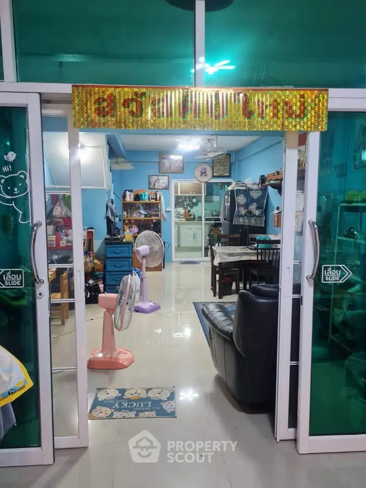 Charming interior with sliding glass doors, cozy seating, and vibrant decor in a welcoming living space.