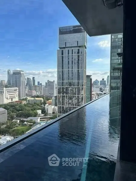 Stunning high-rise view with infinity pool overlooking city skyline