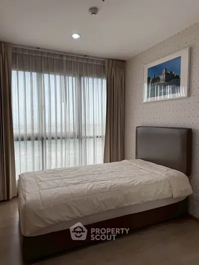 Cozy bedroom with large window and elegant decor in modern apartment