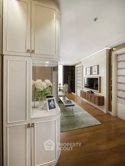 Elegant living room with stylish decor, wooden flooring, and built-in shelving, perfect for modern living.