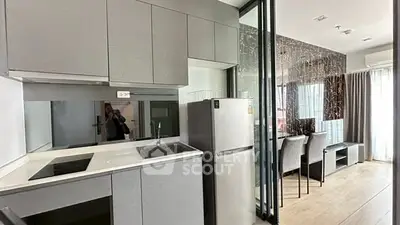 Modern kitchen with sleek cabinetry and open layout in stylish apartment.