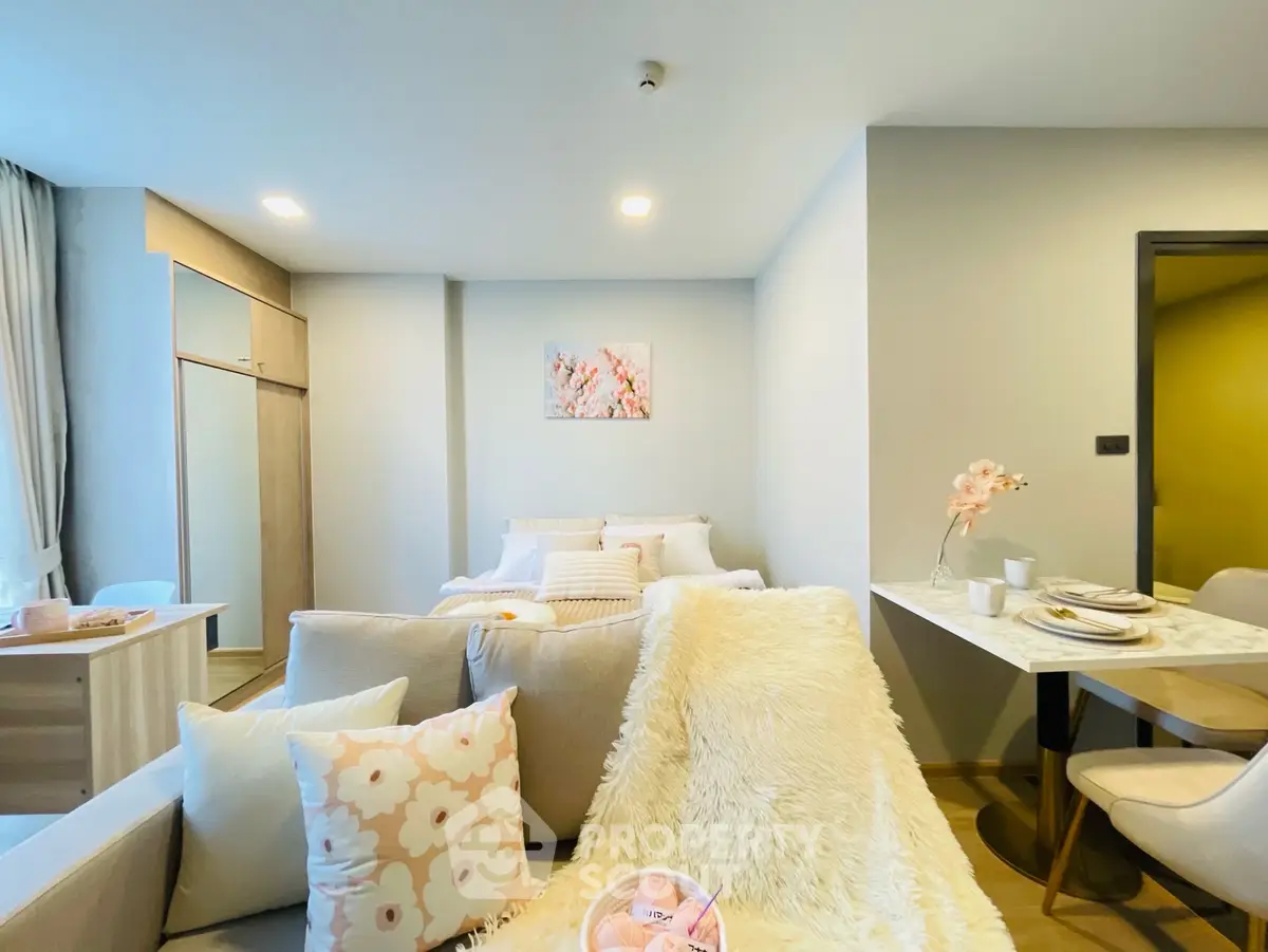 Cozy and stylish living room with modern decor and dining area in open layout apartment.