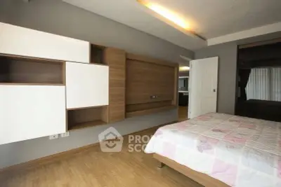 Modern bedroom with stylish wooden flooring and contemporary wall-mounted storage units.
