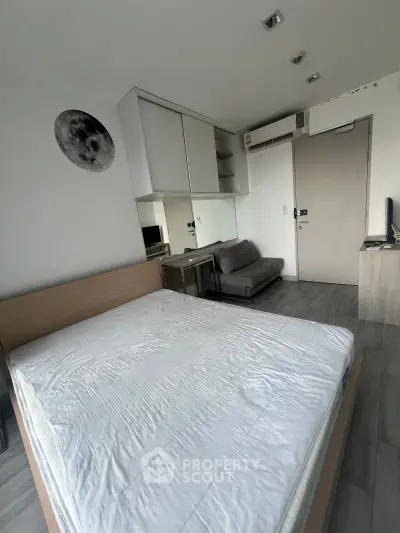 Modern bedroom with minimalist design, featuring a comfortable bed, sleek furniture, and stylish decor.