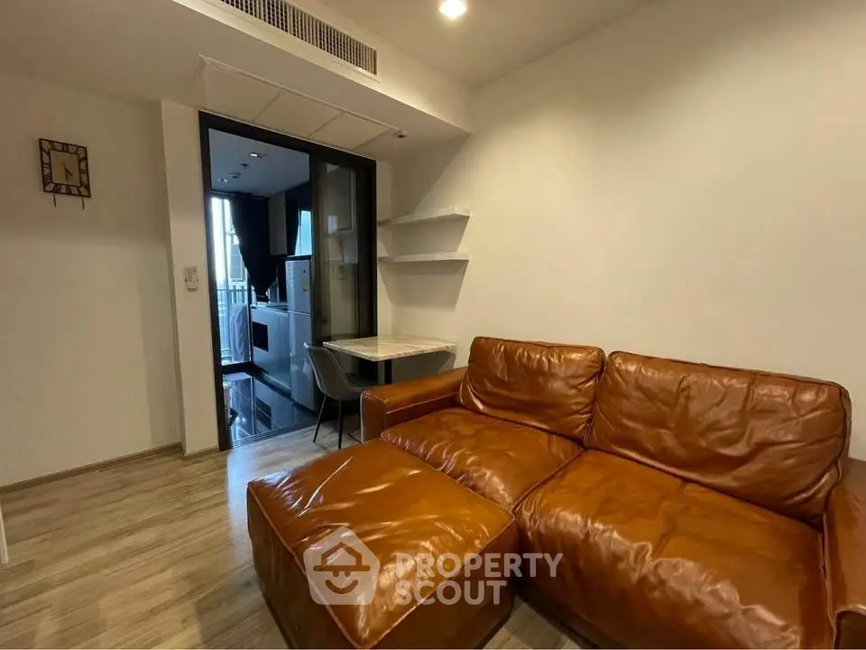 Cozy living room with brown leather sofa and modern decor