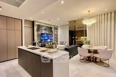 Luxurious open-plan living room and kitchen with modern decor and elegant lighting.