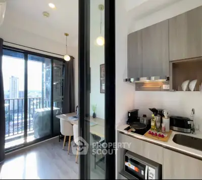 Modern apartment kitchen with open layout and balcony view