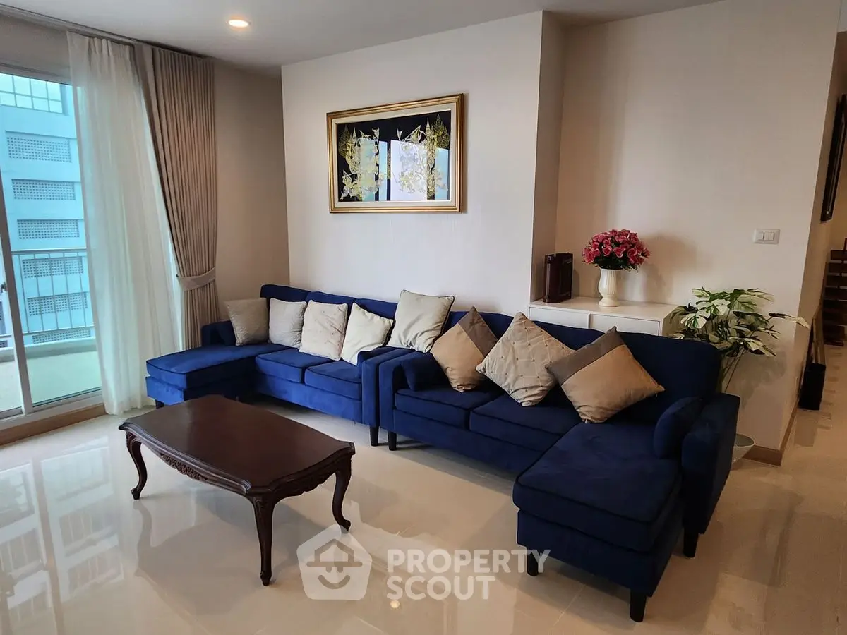 Spacious living room with elegant blue sofa and modern decor