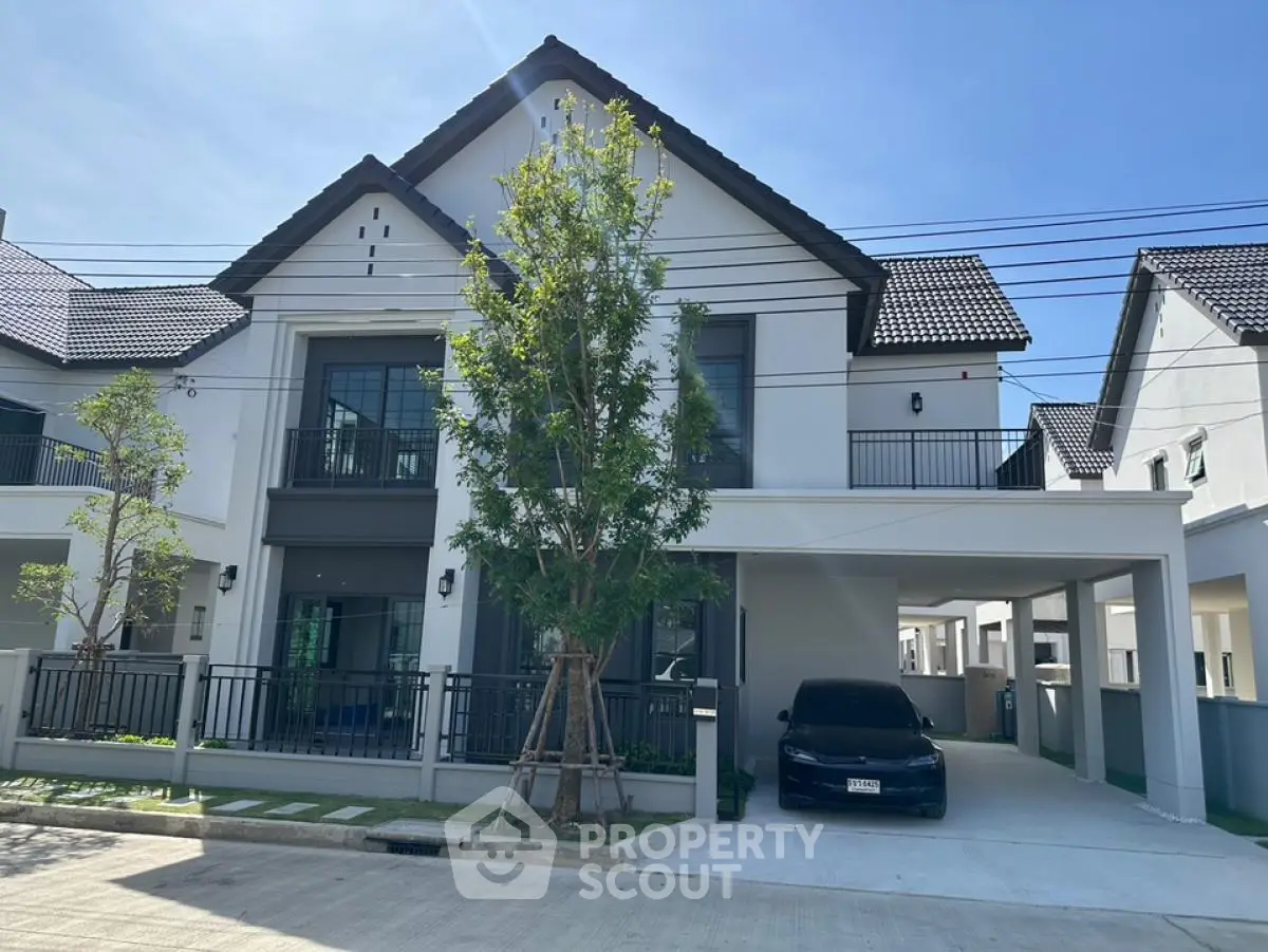 Modern two-story house with sleek design and spacious driveway