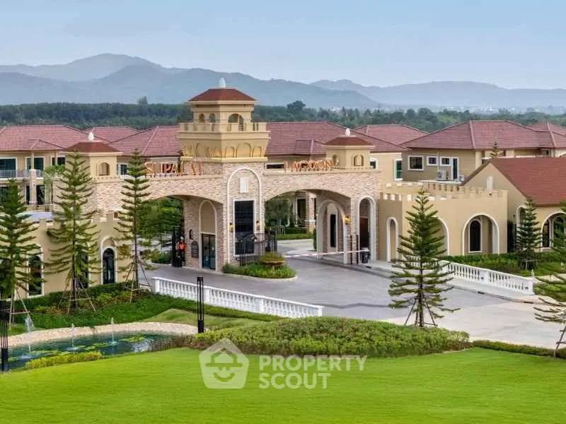 Luxurious gated community entrance with scenic mountain backdrop