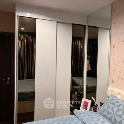 Modern bedroom with mirrored wardrobe and stylish decor