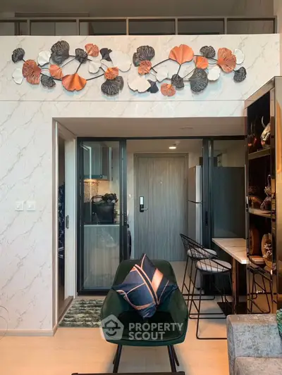 Modern living room with stylish decor and open kitchen layout in a chic apartment.