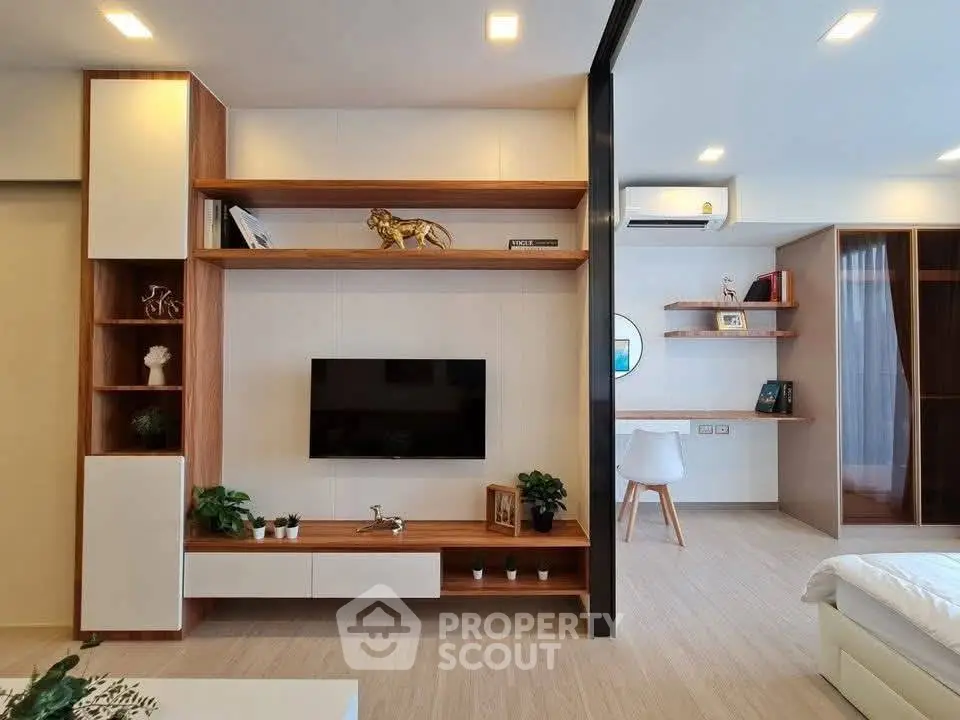 Modern living room with sleek wooden shelves and stylish decor in a contemporary apartment.