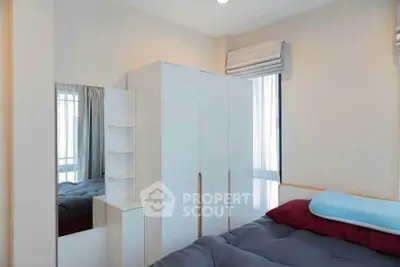 Cozy bedroom with modern wardrobe and ample natural light