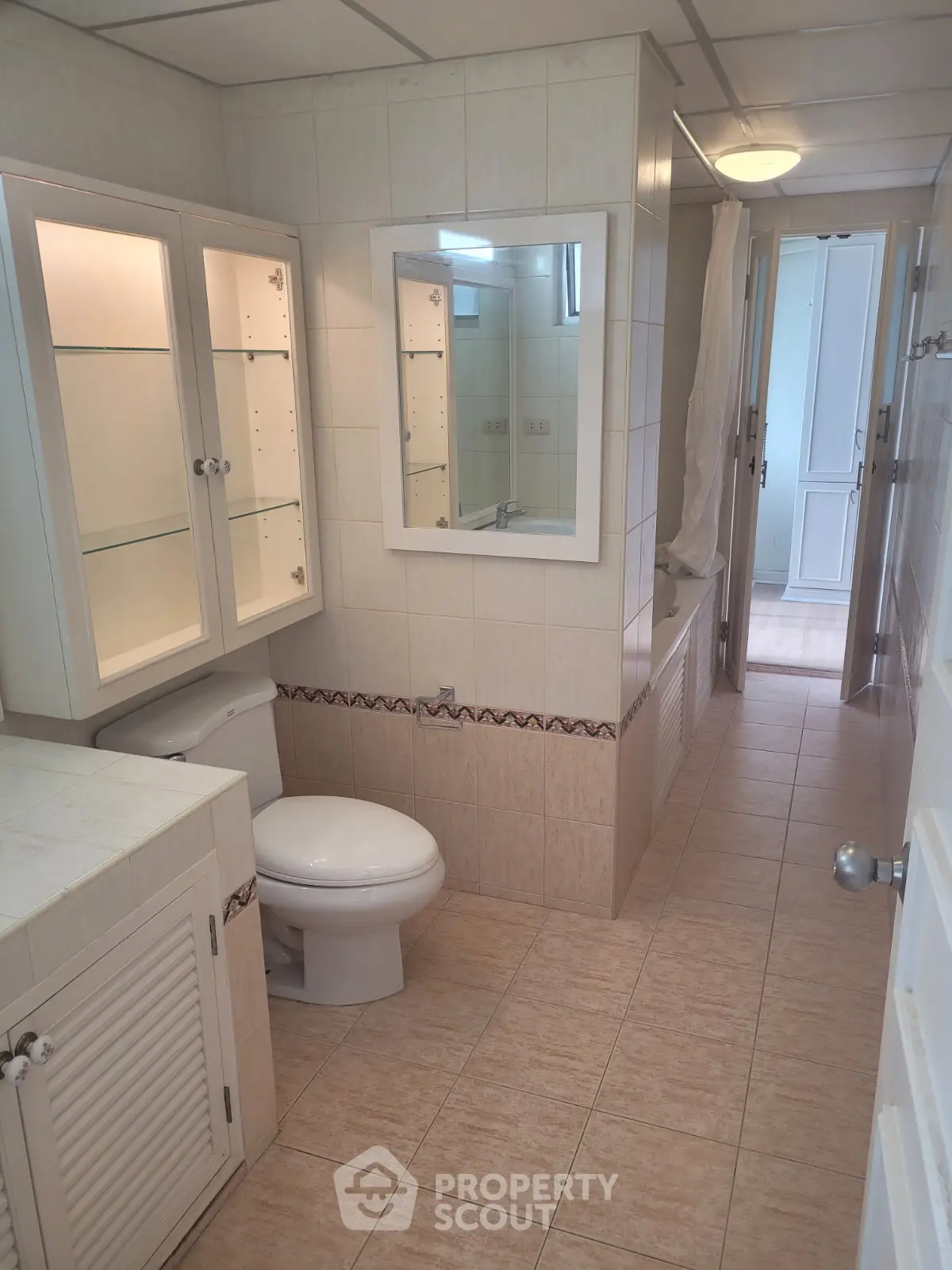 Spacious bathroom with elegant cabinetry and modern fixtures in a well-lit home.