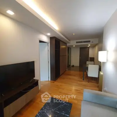 Modern living room with sleek wooden flooring and stylish furniture