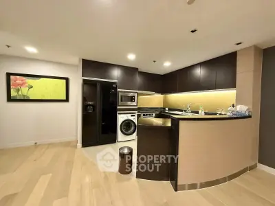 Modern kitchen with sleek appliances and stylish cabinetry in a contemporary apartment.