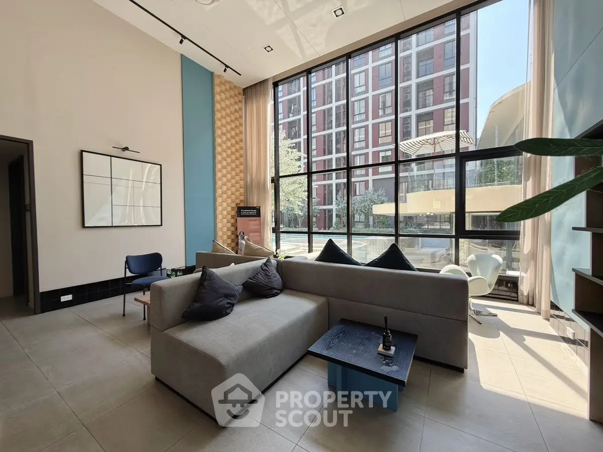 Modern living room with large windows and stylish furniture in urban apartment