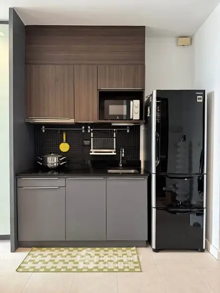 Modern compact kitchen with sleek black appliances and stylish cabinetry