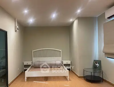 Modern bedroom with stylish bed frame and cozy lighting, perfect for relaxation.