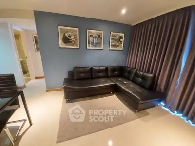 Modern living room with sleek black leather sectional sofa and stylish decor