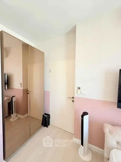 Modern bedroom with mirrored wardrobe and sleek decor