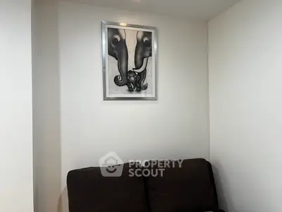 Cozy living room corner with modern art and dark sofa