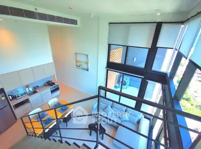Stunning modern loft with floor-to-ceiling windows and open kitchen layout, offering breathtaking city views.