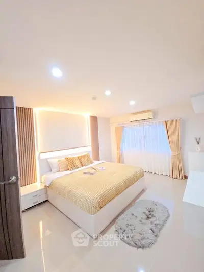 Spacious modern bedroom with elegant decor and natural light