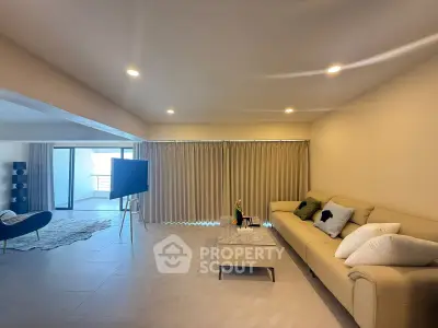 Spacious modern living room with elegant decor and ample natural light, perfect for relaxation and entertainment.