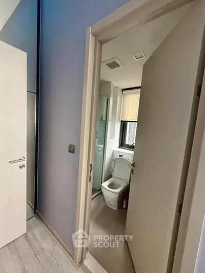 Modern compact bathroom with sleek design and large window for natural light.