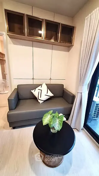 Cozy living room with modern sofa, stylish coffee table, and elegant decor in a bright apartment.