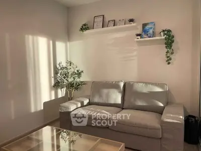 Cozy living room with modern gray sofa and stylish decor, perfect for relaxation and comfort.