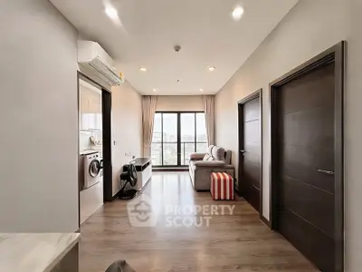 Modern apartment interior with spacious living room and city view, featuring sleek wooden flooring and stylish decor.