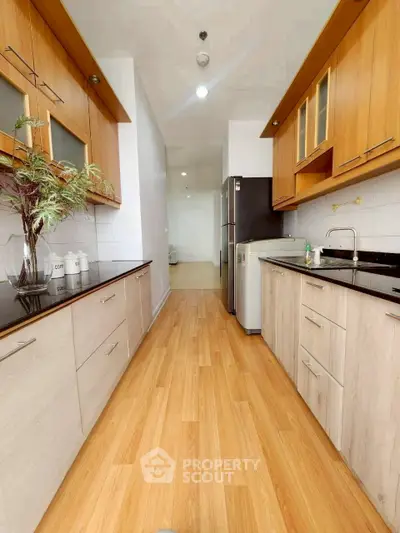 Modern kitchen with sleek wooden cabinets and stainless steel appliances