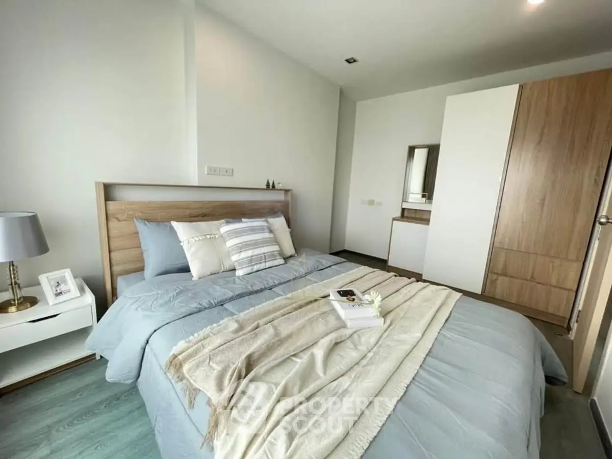 Cozy bedroom with modern decor and wooden accents, perfect for relaxation.