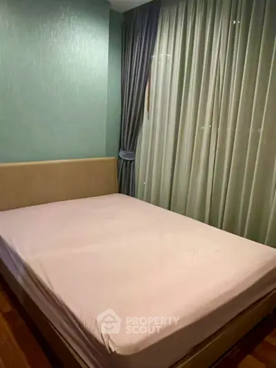Cozy bedroom with elegant curtains and a comfortable bed, perfect for relaxation.