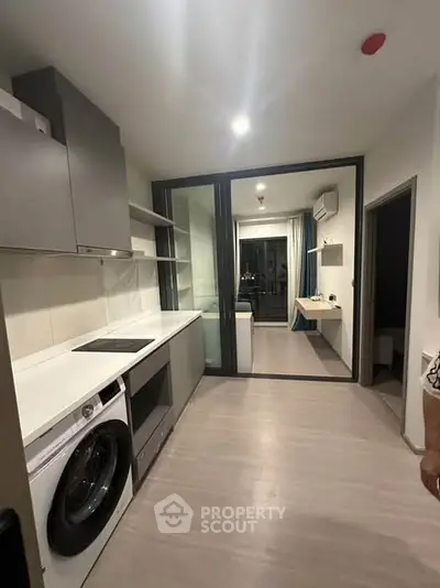 Modern kitchen with sleek design and integrated appliances in a contemporary apartment.