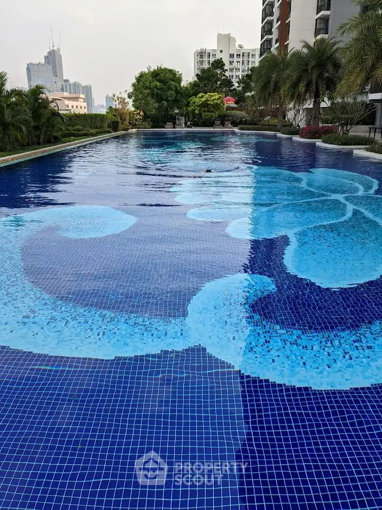 Luxurious outdoor pool with stunning cityscape views and lush greenery