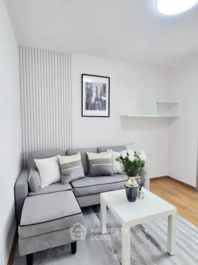 Modern living room with stylish gray sofa and elegant decor