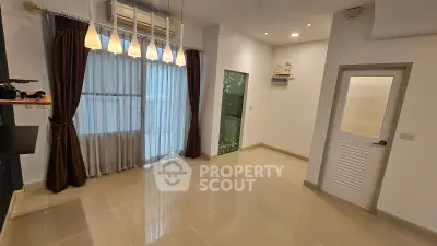 Spacious unfurnished room with large window and modern lighting in a contemporary apartment.