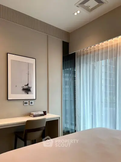 Modern bedroom with elegant decor and large window offering natural light and city view.