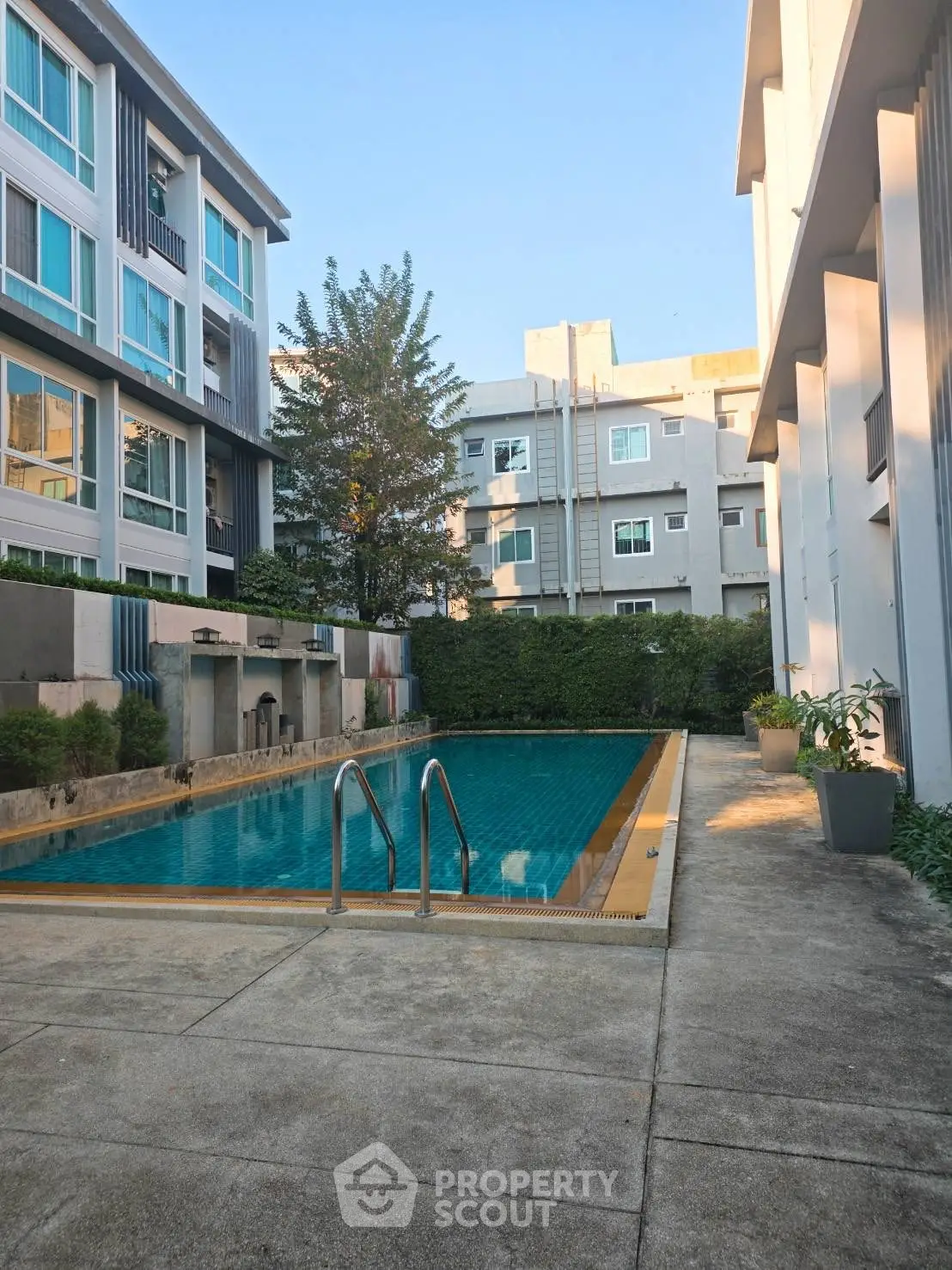 Modern apartment complex with inviting outdoor pool and lush greenery