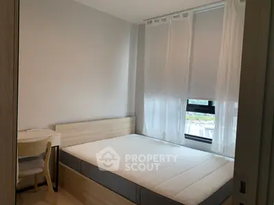 Cozy bedroom with natural light and modern furnishings, ideal for restful living.