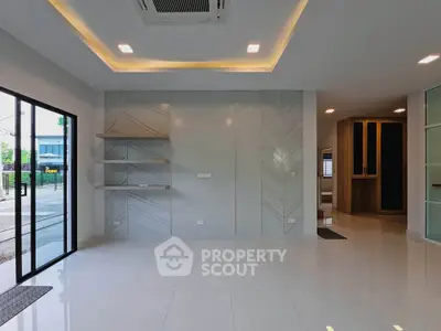 Modern living room with sleek design and large windows for natural light