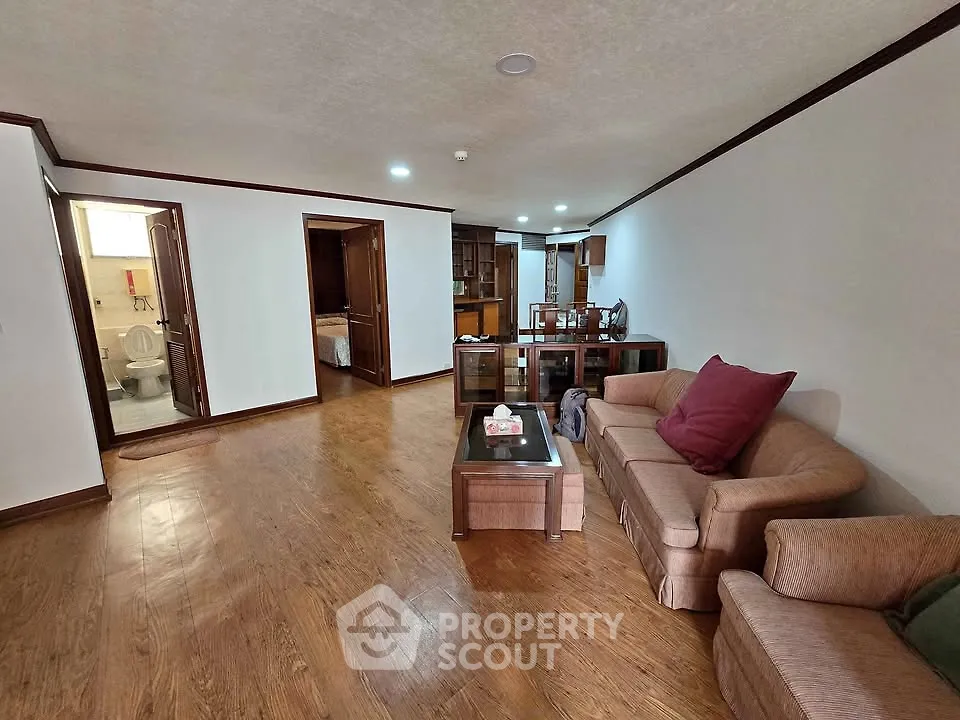 Spacious living room with wooden flooring and cozy furniture