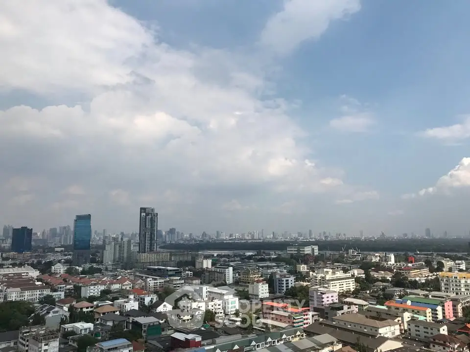 Stunning cityscape view from high-rise building showcasing urban skyline and residential areas.