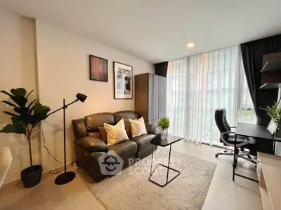 Modern living room with stylish decor, cozy seating, and natural light from large windows.