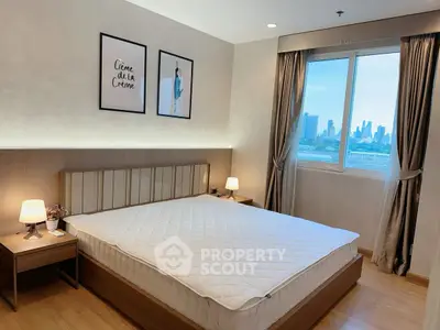 Modern bedroom with city view, featuring elegant decor and natural light.