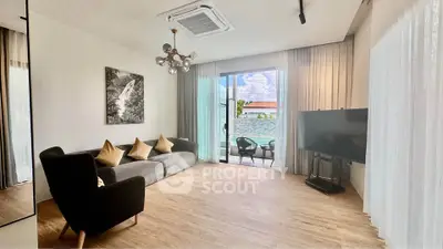 Spacious living room with modern decor and balcony view, perfect for relaxation and entertainment.